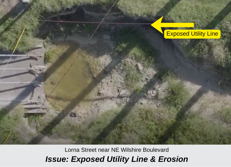 a photo of an exposed utility line in drainage area near Lorna Street