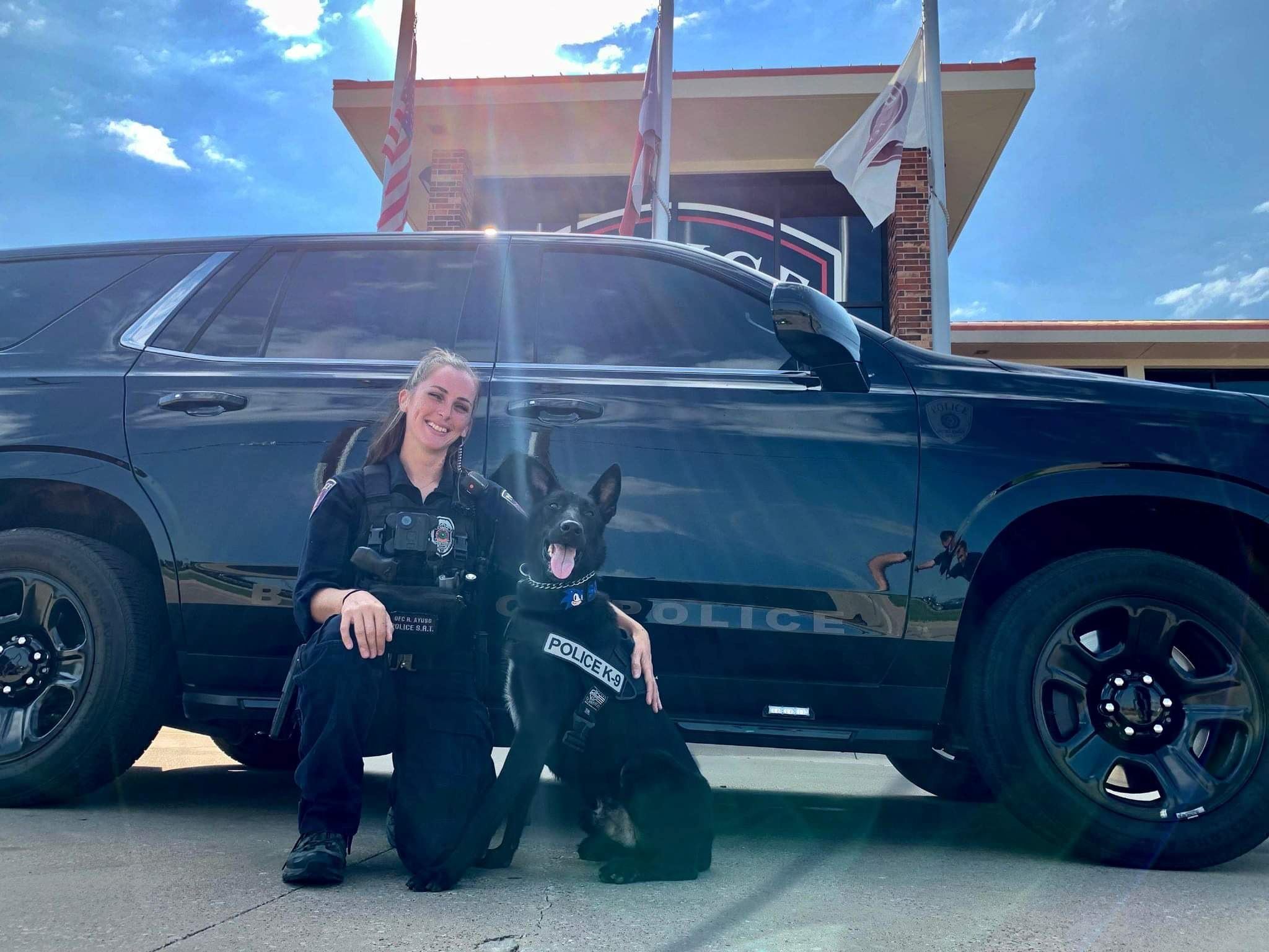 K9 Sonic and Officer Ayuso in front of police cruiser